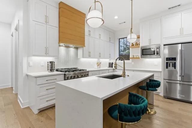 a kitchen with a sink a refrigerator and cabinets