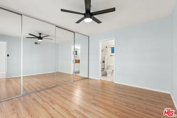a view of an empty room with a ceiling fan