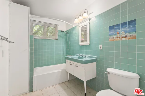 a bathroom with a toilet a sink and bathtub