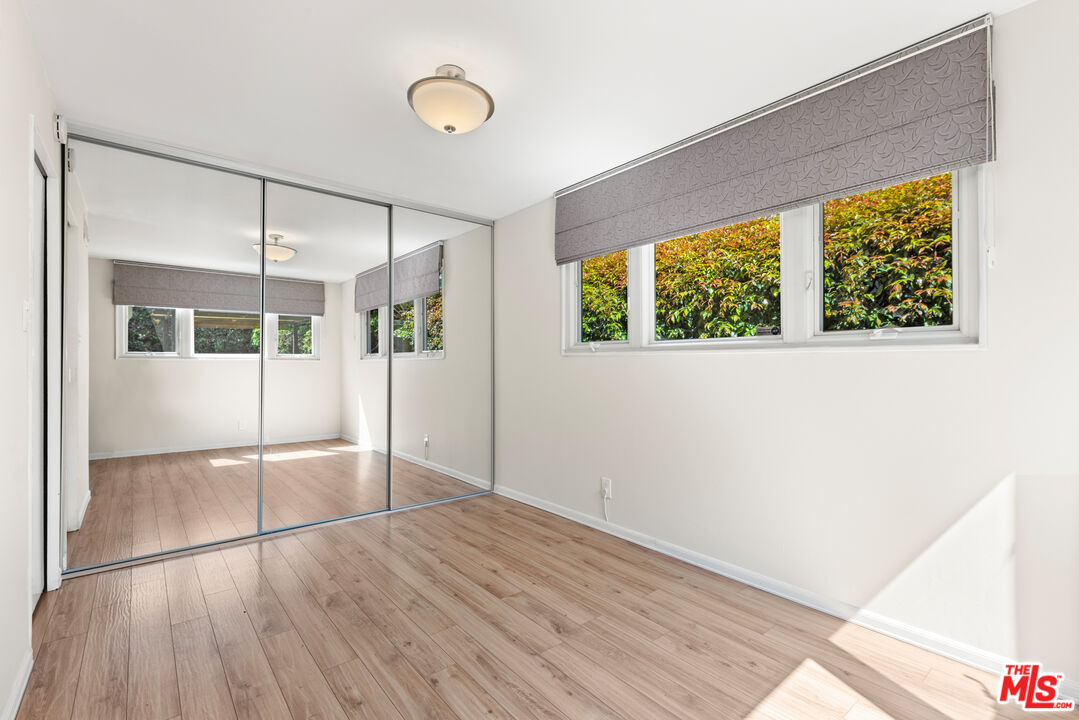 8255 Tuscany Avenue Playa del Rey, CA 90293 - Photo 16 of 24 a view of empty room with wooden floor and fan