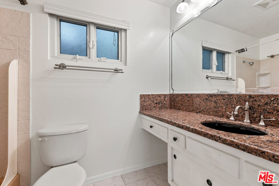 8255 Tuscany Avenue Playa del Rey, CA 90293 - Photo 20 of 24 a bathroom with a granite countertop toilet sink and mirror