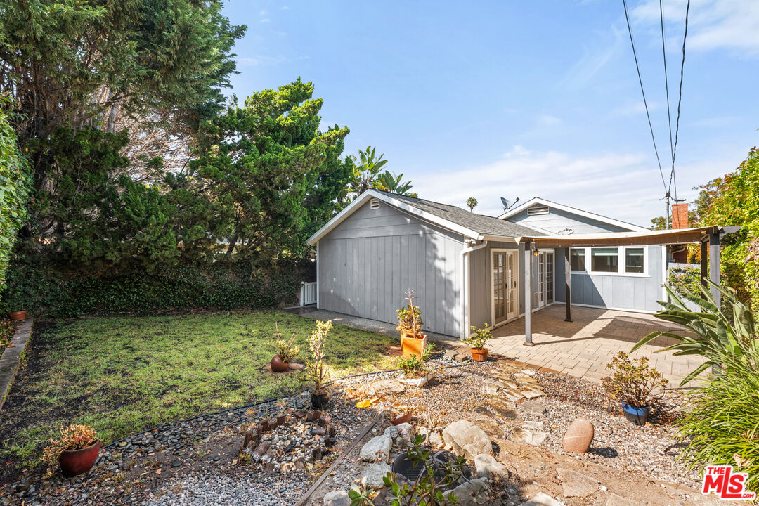 8255 Tuscany Avenue Playa del Rey, CA 90293 - Photo 24 of 24 a front view of a house with a yard and trees