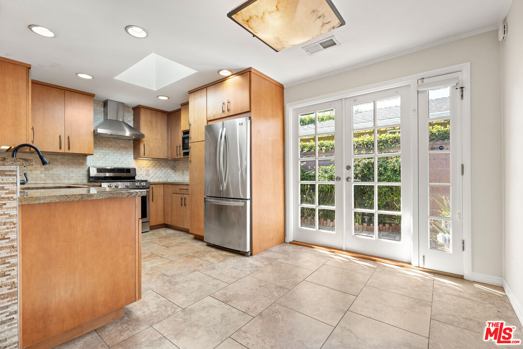 8255 Tuscany Avenue Playa del Rey, CA 90293 - Photo 6 of 24 a kitchen with stainless steel appliances a refrigerator and a stove top oven