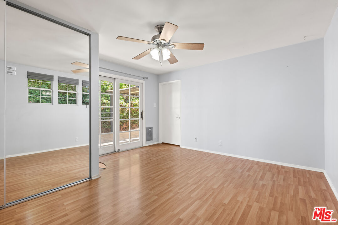 8255 Tuscany Avenue Playa del Rey, CA 90293 - Photo 8 of 24 a view of an empty room with wooden floor and a window