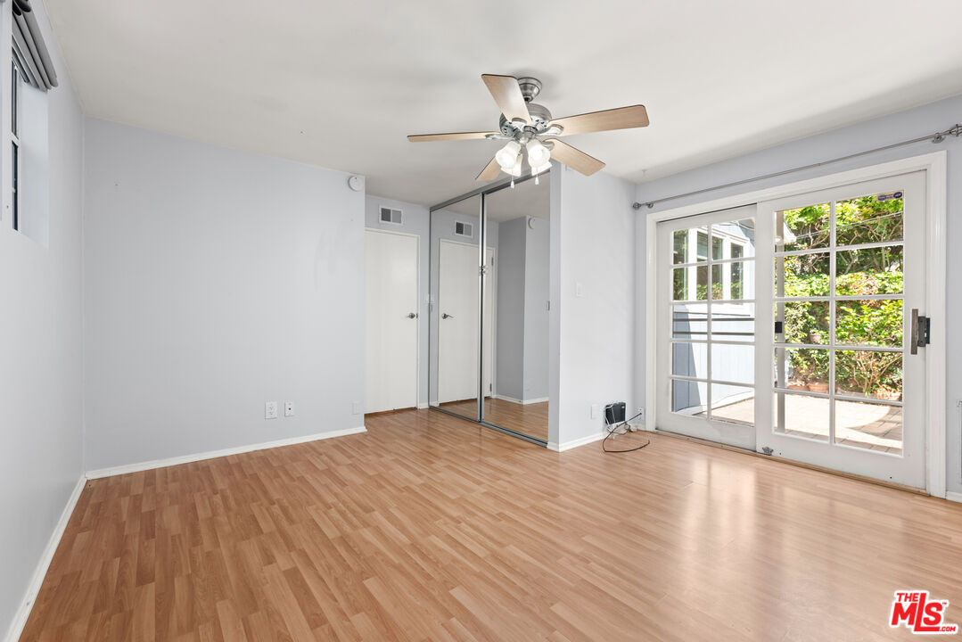 8255 Tuscany Avenue Playa del Rey, CA 90293 - Photo 10 of 24 a view of a livingroom with wooden floor and a ceiling fan