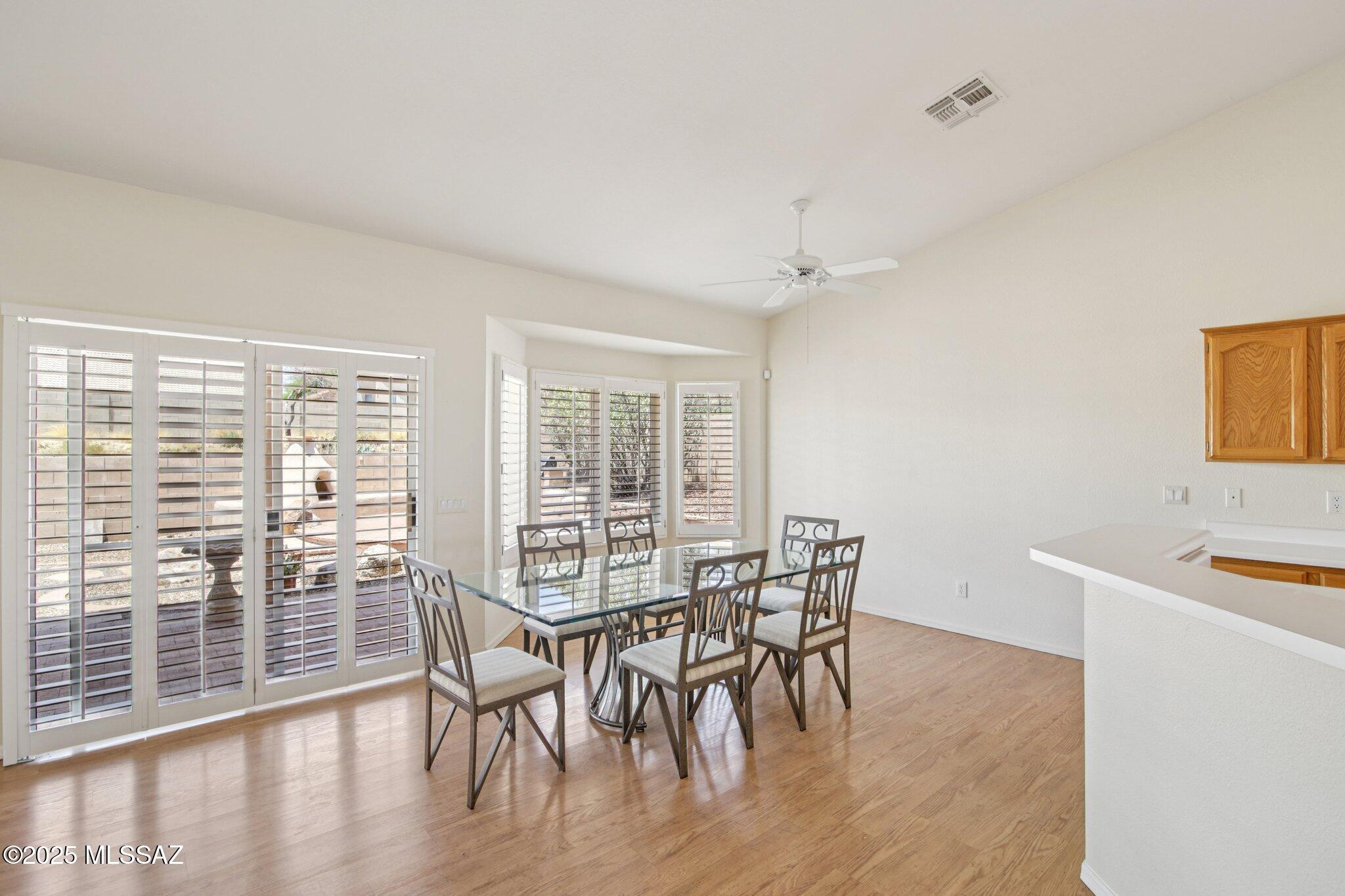 35890 Mesa Ridge Drive Tucson, AZ 85739 - Photo 7 of 31 a view of a dining room with furniture and wooden floor