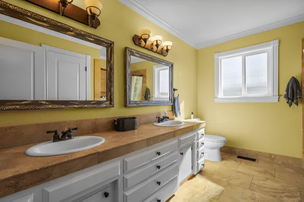 a bedroom with a bed and a painting on the wall