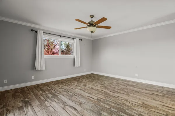a view of a ceiling fan and wooden floor