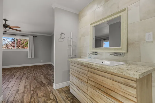 a view of a livingroom with wooden floor and a flat screen tv