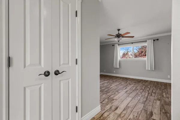 a view of an empty room with wooden floor