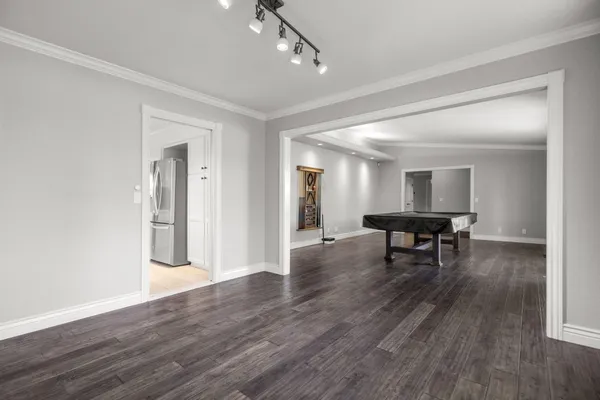 a metallic refrigerator freezer and a stove sitting inside of a kitchen