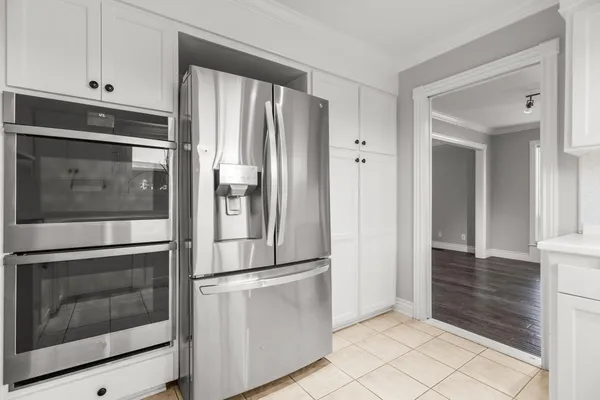 a kitchen with cabinets and chairs