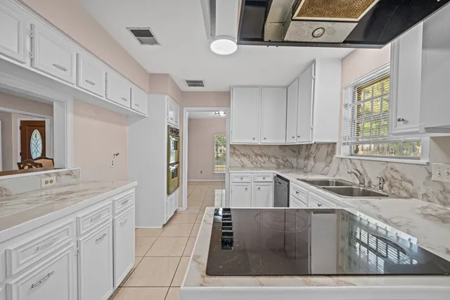 a kitchen with stainless steel appliances granite countertop a sink and cabinets