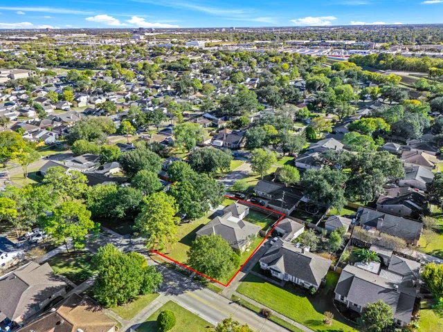 an aerial view of residential houses with outdoor space