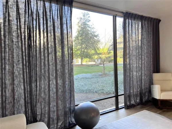 a view of a room with a large window and floor to ceiling window