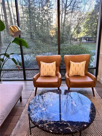 a bedroom with furniture and a large window