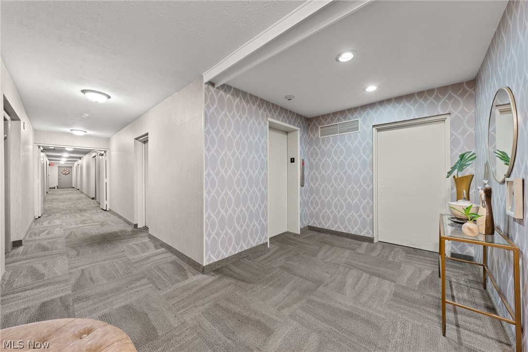 3070 Kent Road, Unit 312D Stow, OH 44224 - Photo 6 of 49 Hallway featuring patterned wall coverings, recessed lighting, and patterned carpet flooring