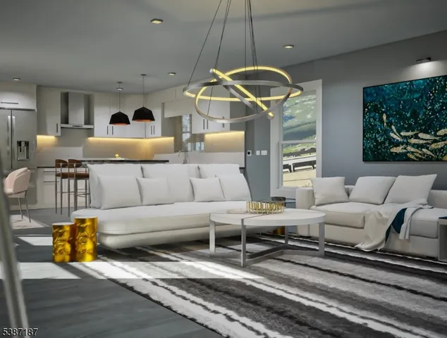 a living room with furniture and a chandelier