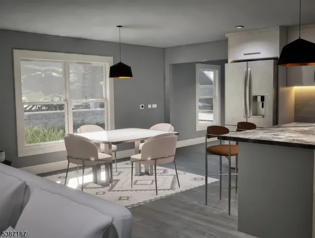 a dining room with furniture and wooden floor