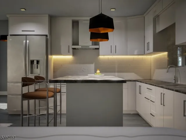 a kitchen with granite countertop a refrigerator a stove and a sink