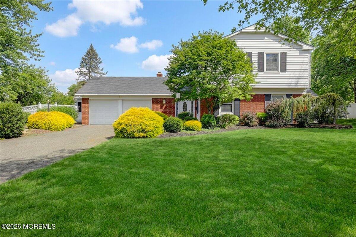 a front view of house with yard and trees