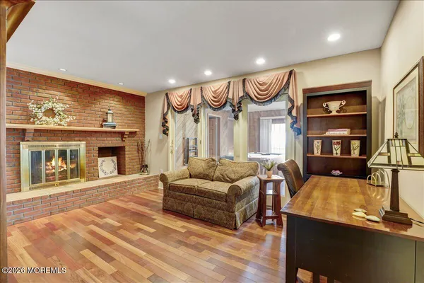 a dining room with furniture a chandelier and wooden floor