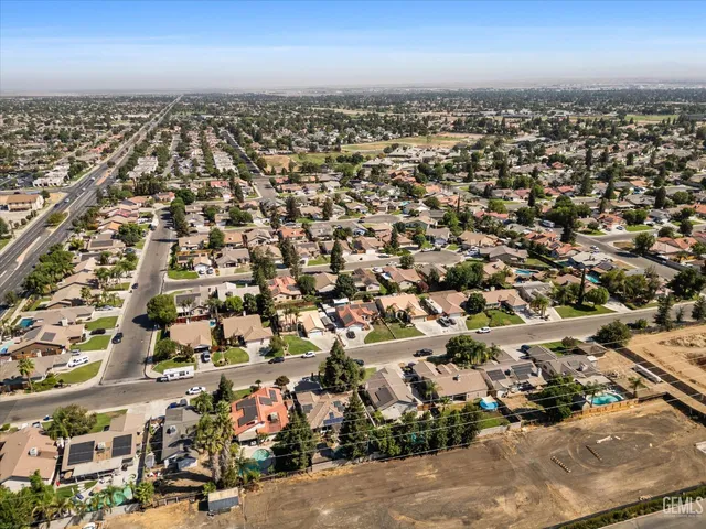 a front view of a house with a garden and trees