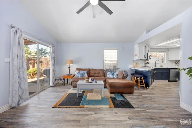 a kitchen with stainless steel appliances granite countertop white cabinets a sink and a stove