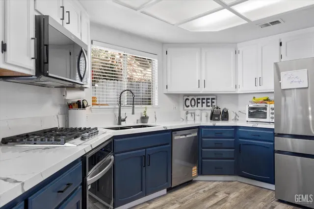 a kitchen with wooden cabinets and stainless steel appliances