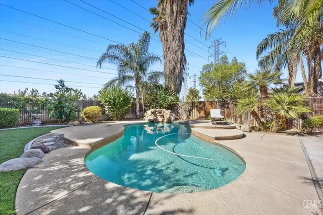 a view of house with outdoor space and swimming pool
