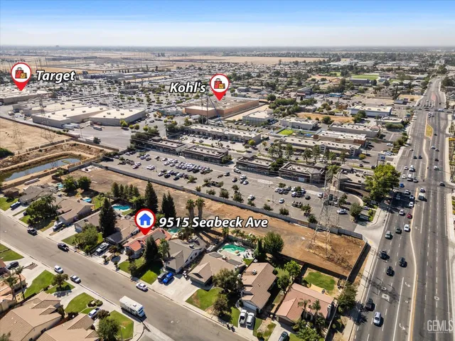 a front view of house with yard and trees in the background