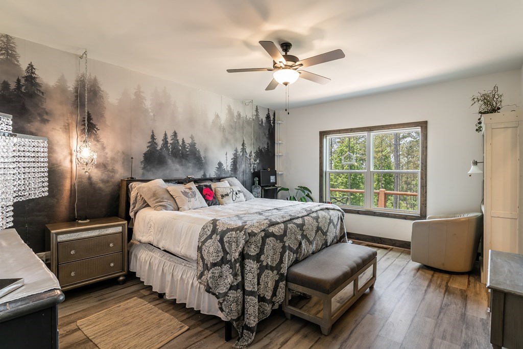 230 High River Road Ellijay, GA 30540 - Photo 8 of 27 a bedroom with a bed couch and wooden floor