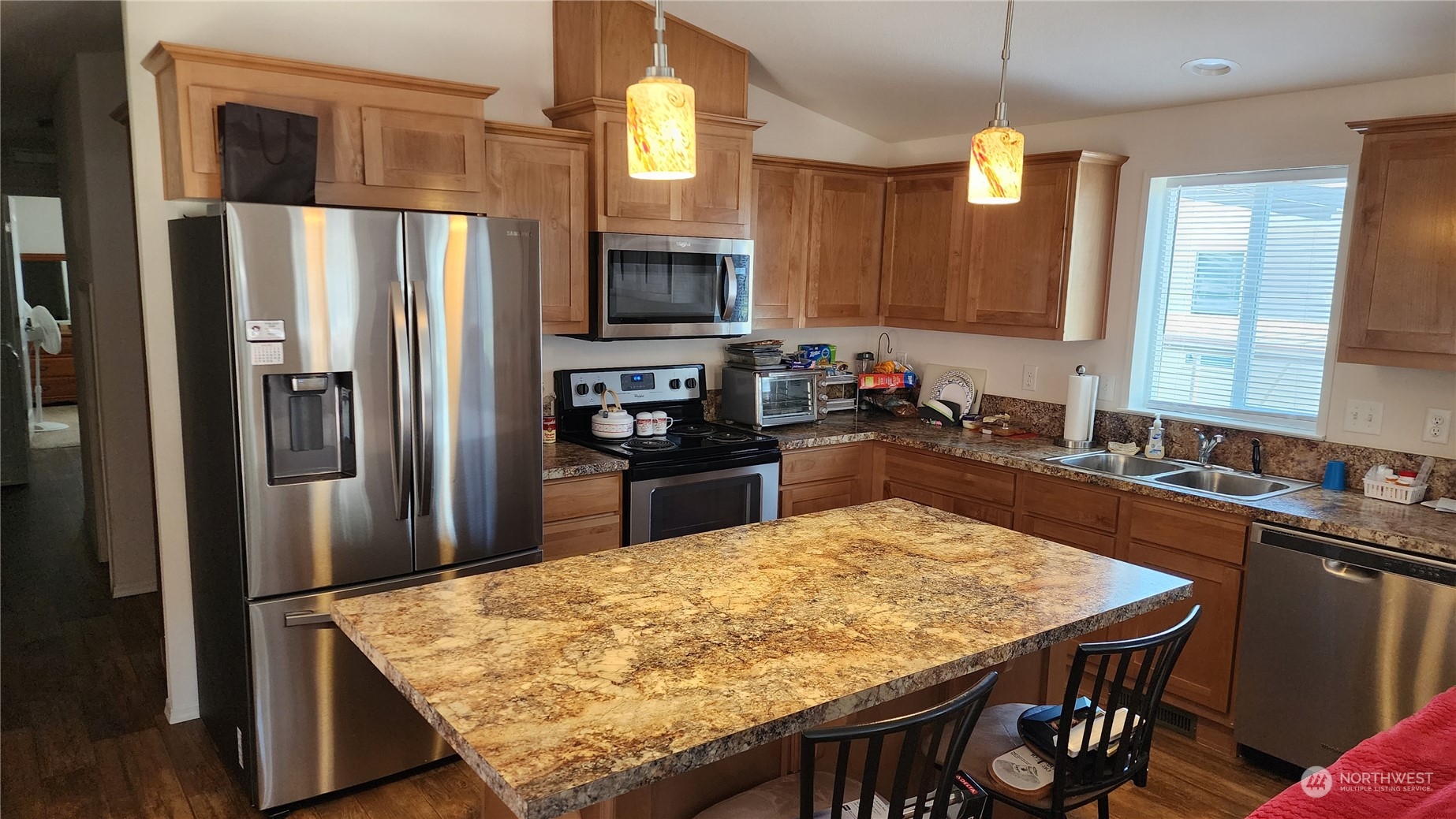 807 Mountain Villa Drive Enumclaw, WA 98022 - Photo 12 of 15 a kitchen with a table chairs refrigerator and microwave