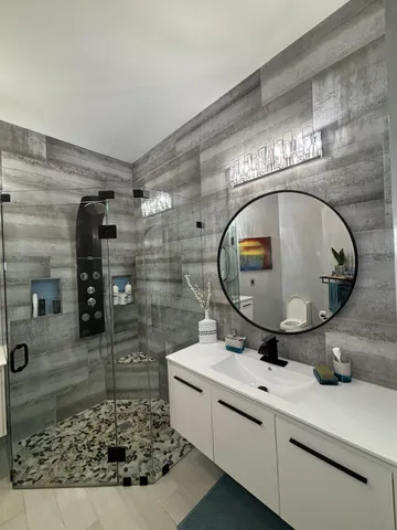 a bedroom with a large bed and a chandelier