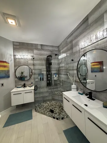 a bathroom with a sink a toilet and shower