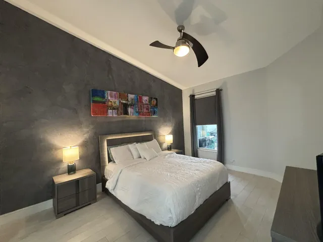 a bed room with a bed mirror and window