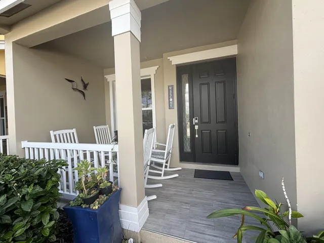 a view of front door and porch with seating space