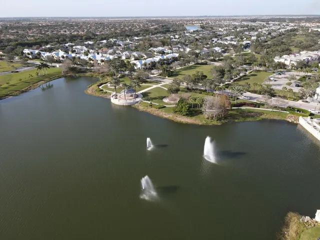 an aerial view of a houses with a lake