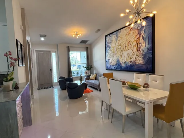 a living room with furniture and paintings on the wall