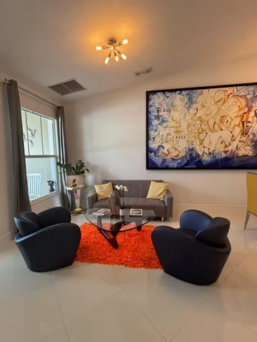 a living room with furniture pool and a large window