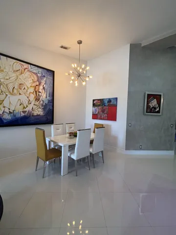 a view of a dining room with furniture and chandelier