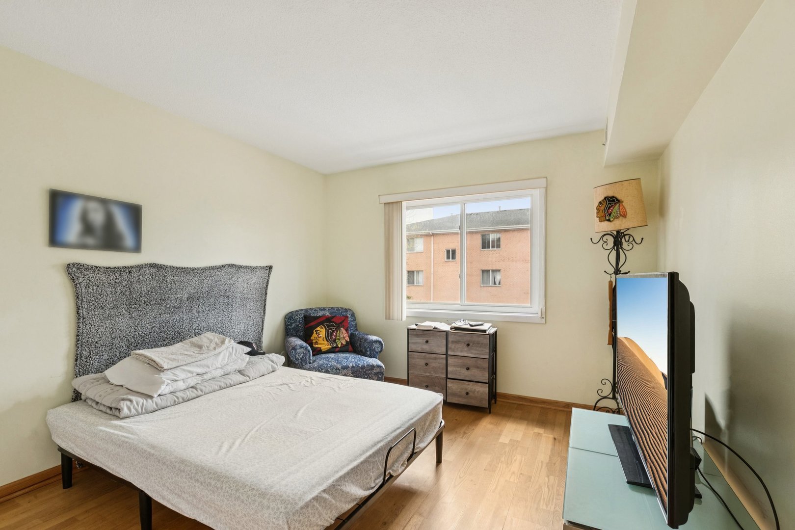 702 Cobblestone Circle, Unit D Glenview, IL 60025 - Photo 13 of 25 a bedroom with a bed and a flat tv screen on dresser