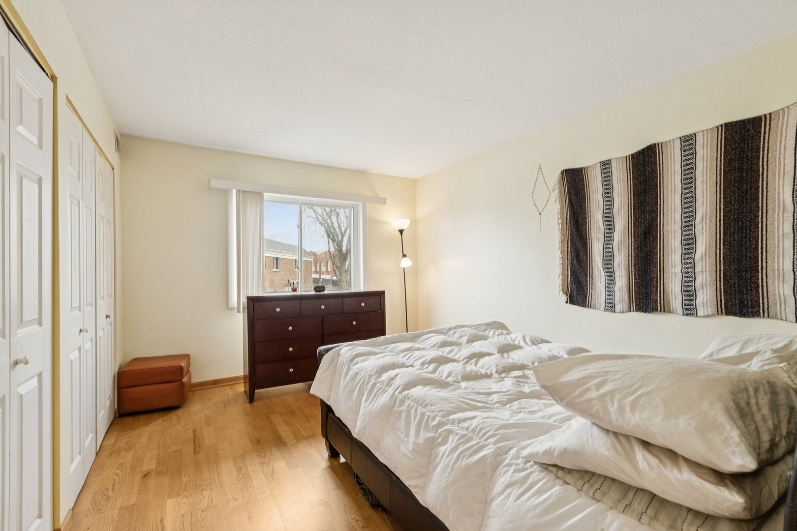 702 Cobblestone Circle, Unit D Glenview, IL 60025 - Photo 17 of 25 a bedroom with a bed and wooden floor