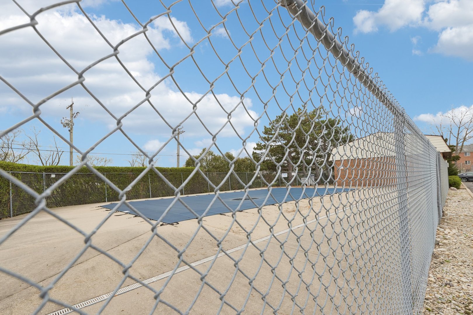 702 Cobblestone Circle, Unit D Glenview, IL 60025 - Photo 24 of 25 a view of a wooden fence and sign