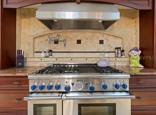 a white stove top oven sitting inside of a kitchen