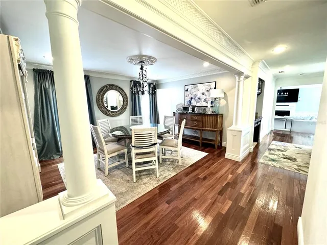 a view of a dining room with furniture window and wooden floor