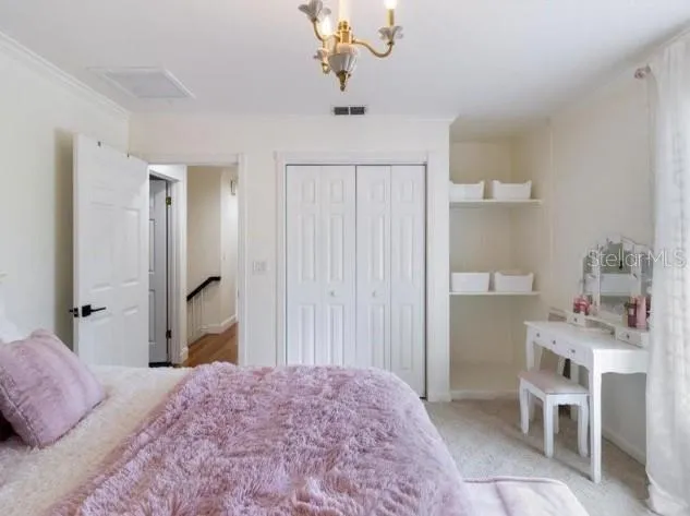 a bedroom with a bed and a dresser in it