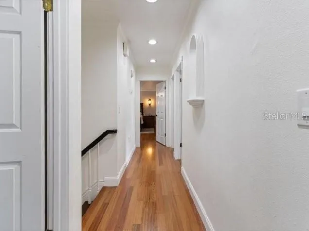 a view of a hallway with wooden floor