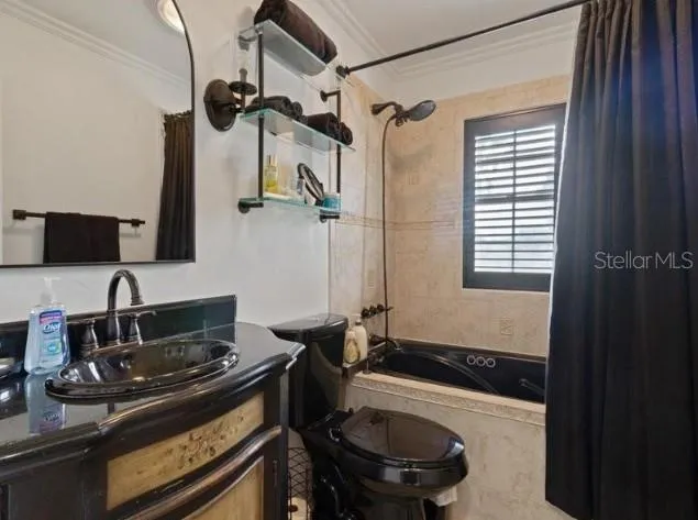 a bathroom with a granite countertop sink a toilet and bathtub