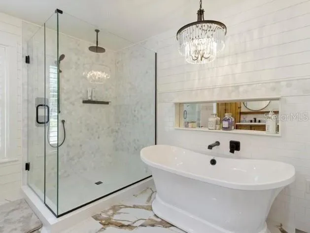 a bathroom with a sink a mirror and shower